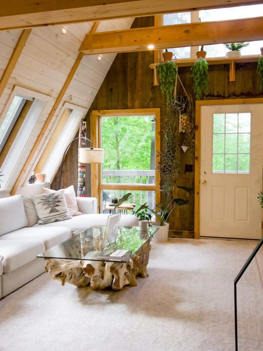 An A-frame loft under skylights, doors onto a deck