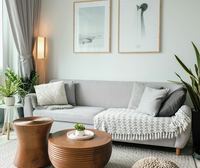 The sitting corner, plants and framed prints on a pale wall