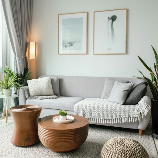 The sitting corner, plants and framed prints on a pale wall