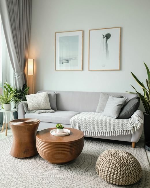 The sitting corner, plants and framed prints on a pale wall