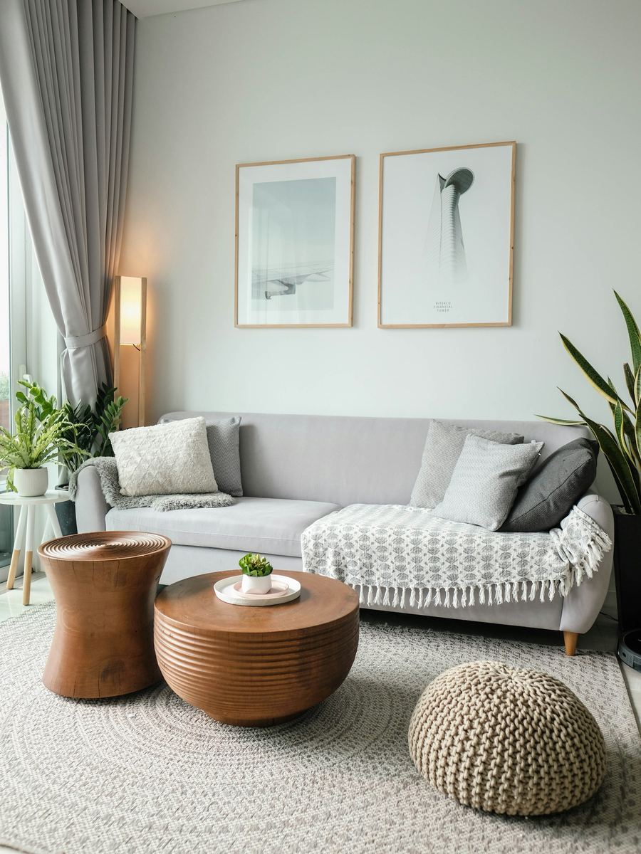 A living room with a low table, soft chairs and a window onto trees