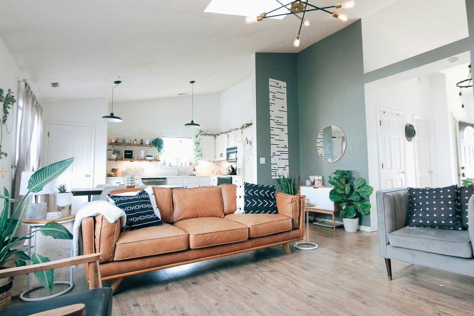 An open-plan living room with a teal wall